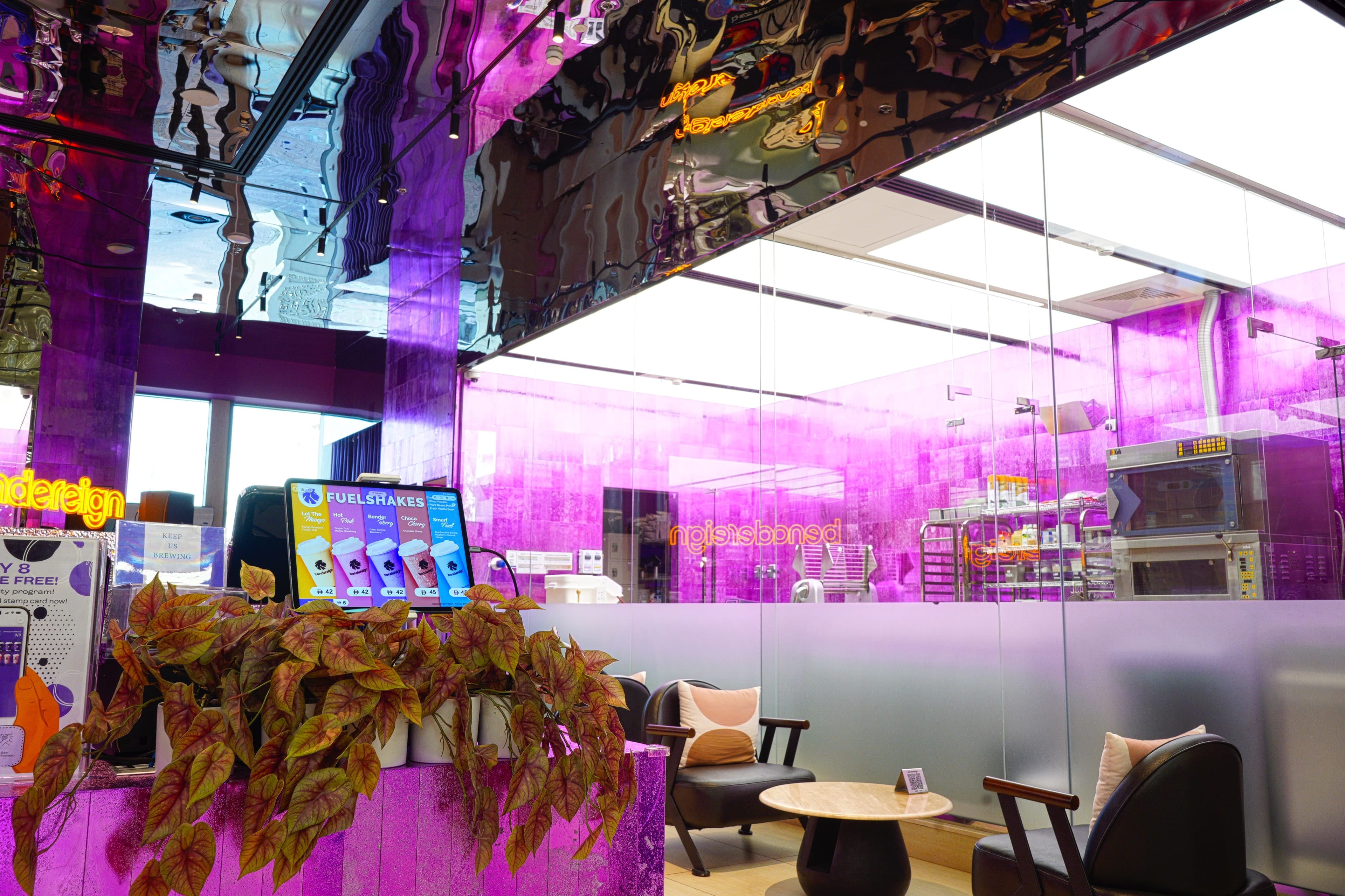 The Bendereign lounge, lit magenta through the resin counter and mirrored ceiling.